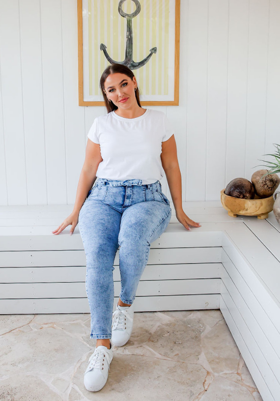 Ladies High Waisted Jeans - Light Blue Acid Wash - Optional Tie Belt at Waist - Functional Front and Back Pockets - Zip Front - Full Length - Sizes 6 - 18 - Daisy Denim Jeans Front Sitting View Size 14 Paired With Daisy White T-Shirt - Daisy's Closet
