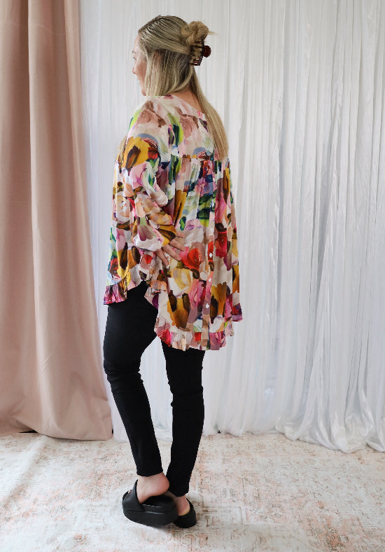 Long sleeve paintbrush print top from Daisy's Closet featuring button-back design and casual fit for women.