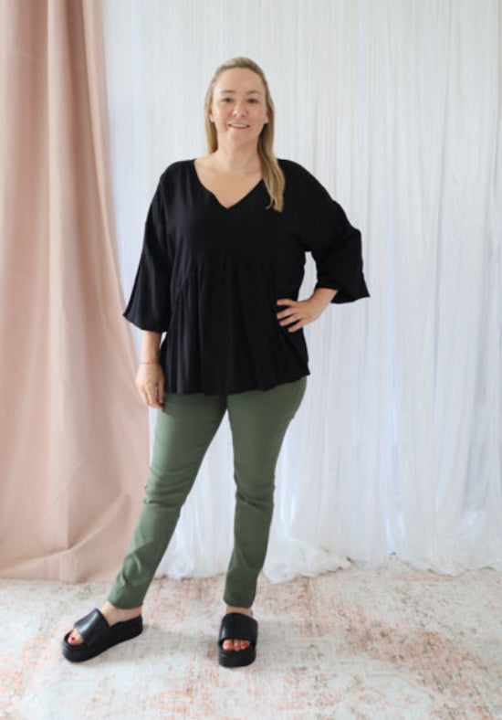 Black long sleeve top from Daisy's Closet Remi collection, featuring a stylish and comfortable design.