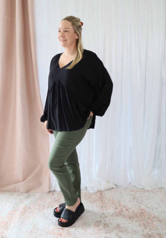 Black long sleeve top from Daisy's Closet featuring a fitted design and crew neckline.