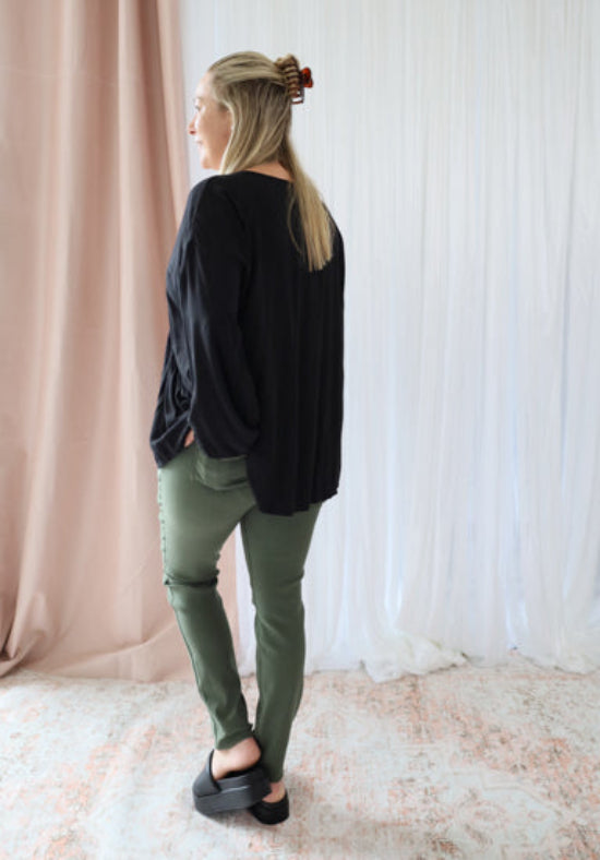 Black long sleeve top from Daisy's Closet's Remi collection, featuring a fitted design and soft fabric.