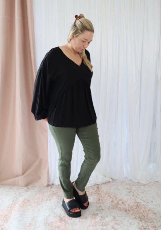 Black long sleeve top from Daisy's Closet Remi collection, featuring a fitted design and soft fabric.