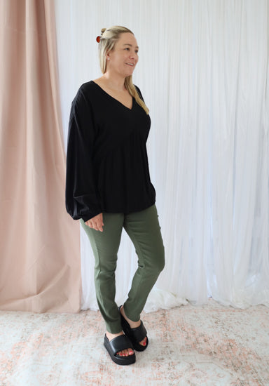 Black long sleeve Remi top from Daisy's Closet, featuring a fitted design and smooth fabric, shown on a mannequin.