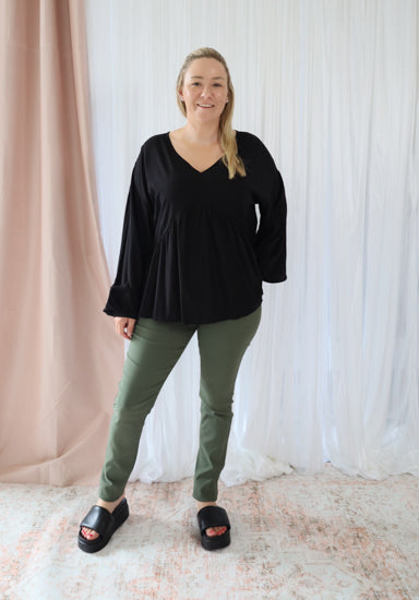 Black long sleeve top from Daisy's Closet Remi collection, stylish and comfortable women's blouse with fitted design.