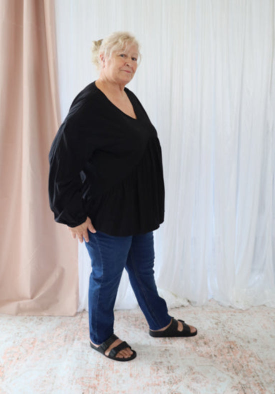 Black long sleeve top from Daisy's Closet, the Remi Top featuring a stylish and comfortable design with a fitted silhouette.