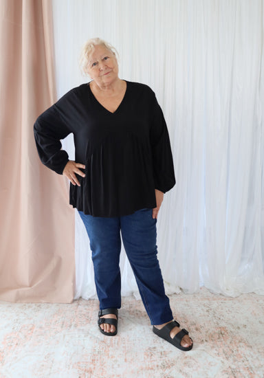 Black long sleeve top from Daisy's Closet, featuring a stylish fit and smooth fabric, ideal for casual or dressy outfits.