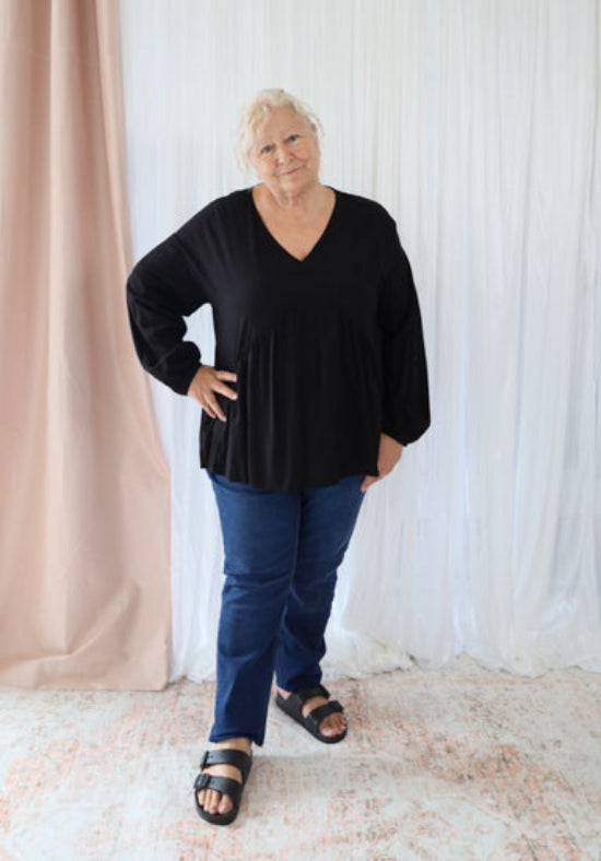 Black long sleeve Remi top from Daisy's Closet, featuring a fitted design and stylish neckline, ideal for casual wear.