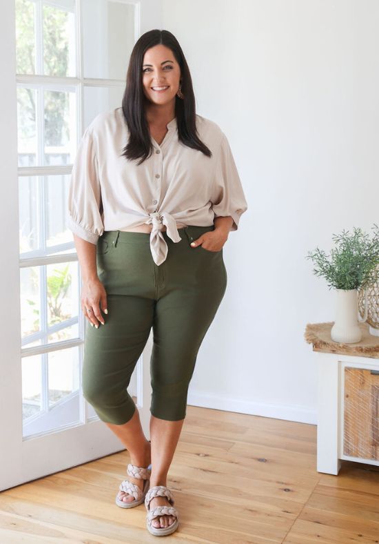 Beige Halley Top from Daisy’s Closet, casual shirt with long sleeves, paired with black jeans in the image.