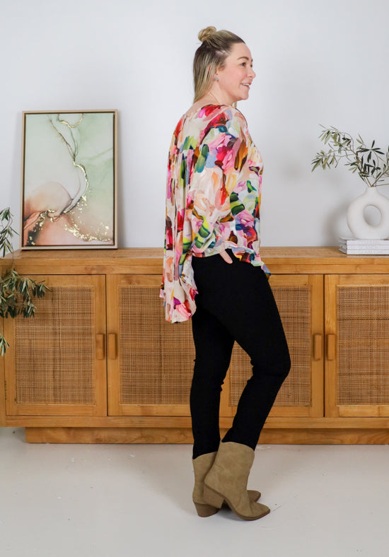 Mila long sleeve paintbrush print top from Daisy's Closet, featuring a colorful artistic design on a casual shirt.