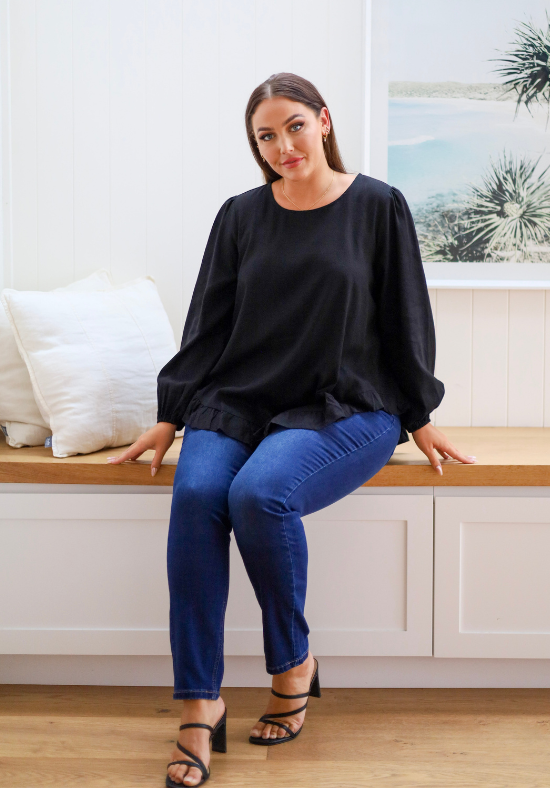 Ladies Long Sleeve Button Back Top - Long Sleeve with Elasticised Cuff - Curved hemline front and back - Sizes S - XXL Available - front sitting view paired with Carter curve dark denim jeans - Daisy's Closet Mila Long Sleeve Top Black