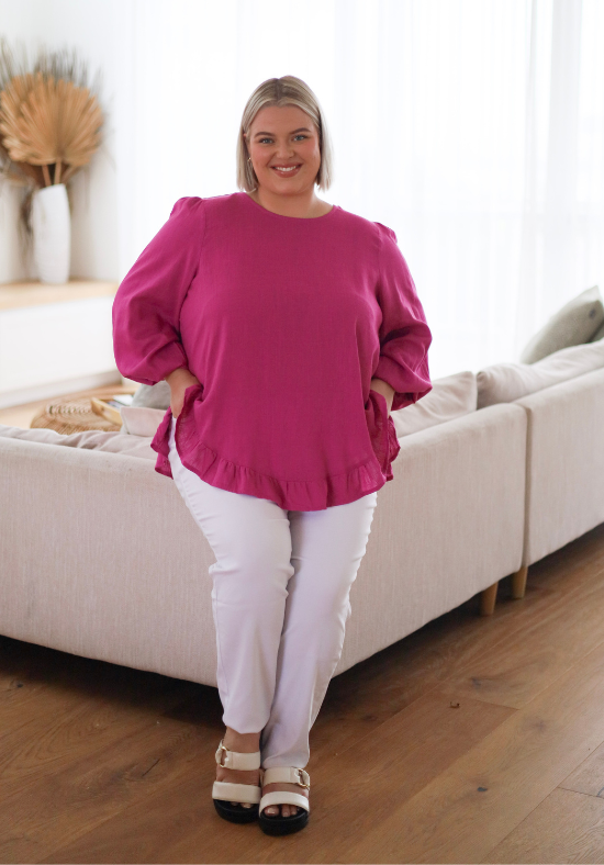 Ladies Long Sleeve Button Back Top - Magenta - Curved Neckline - Curved Hemline front and back - Size XL/XXL Front Sitting View paired with Delta White Denim Jeans - Daisy's Closet Mila Magenta Top
