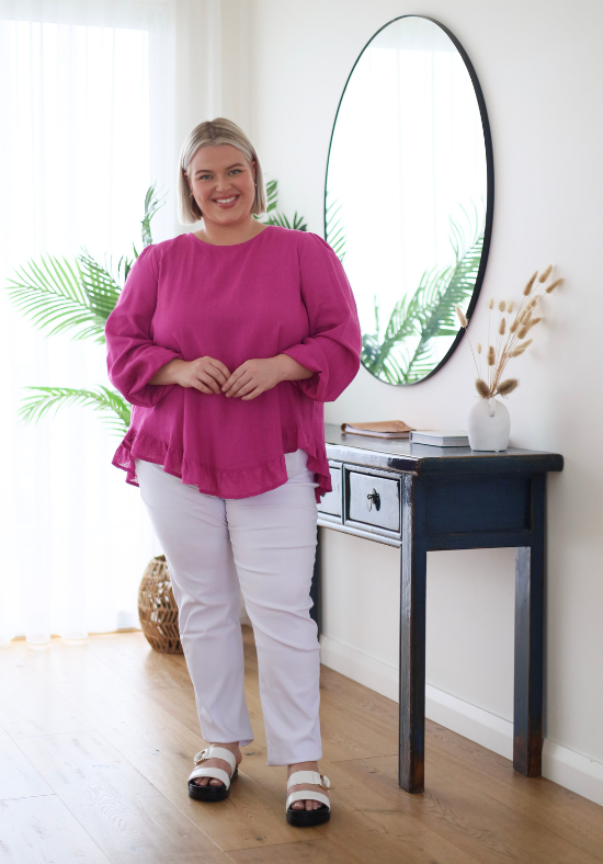 Ladies Long Sleeve Button Back Top - Magenta - Curved Neckline - Curved Hemline front and back - Size L/XL Front Full Length View paired with White Delta Denim Jeans - Daisy's Closet Mila Magenta Top